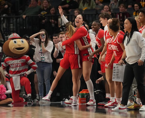 The Ohio State Buckeyes bench erupts as time runs out in a semifinal matchup against Indiana at Target Center in Minneapolis, Minn., on Saturday, Marc