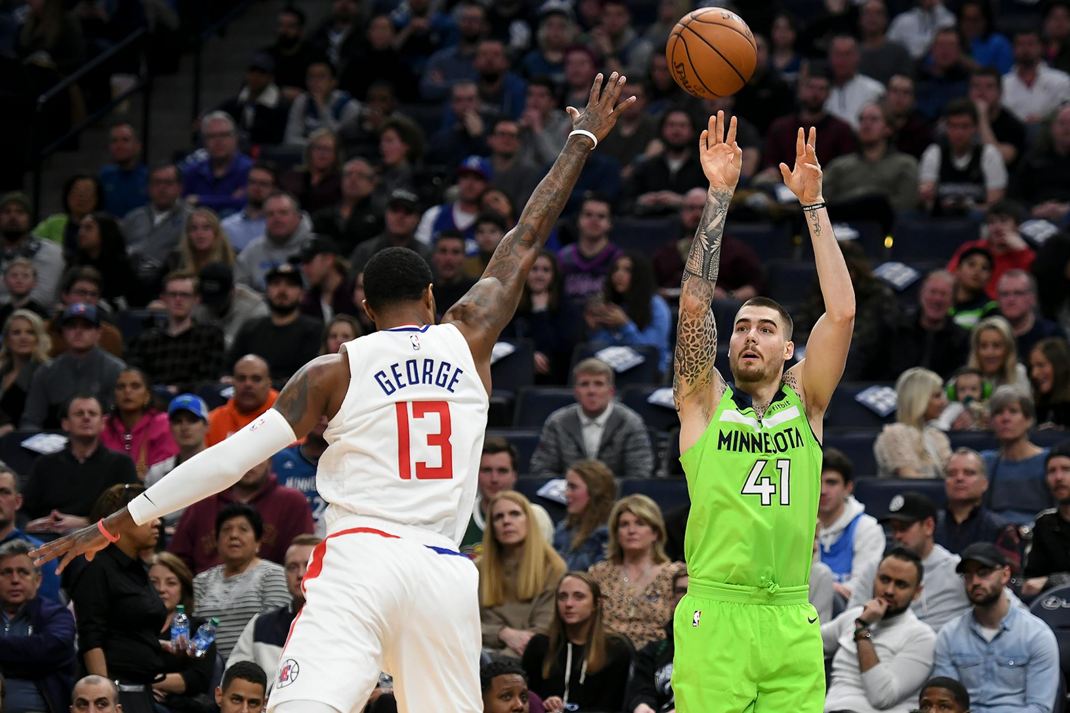 Minnesota Timberwolves forward Juan Hernangomez (41) hit a 3-pointer as he was defended by LA Clippers guard Paul George (13) in the first half.
