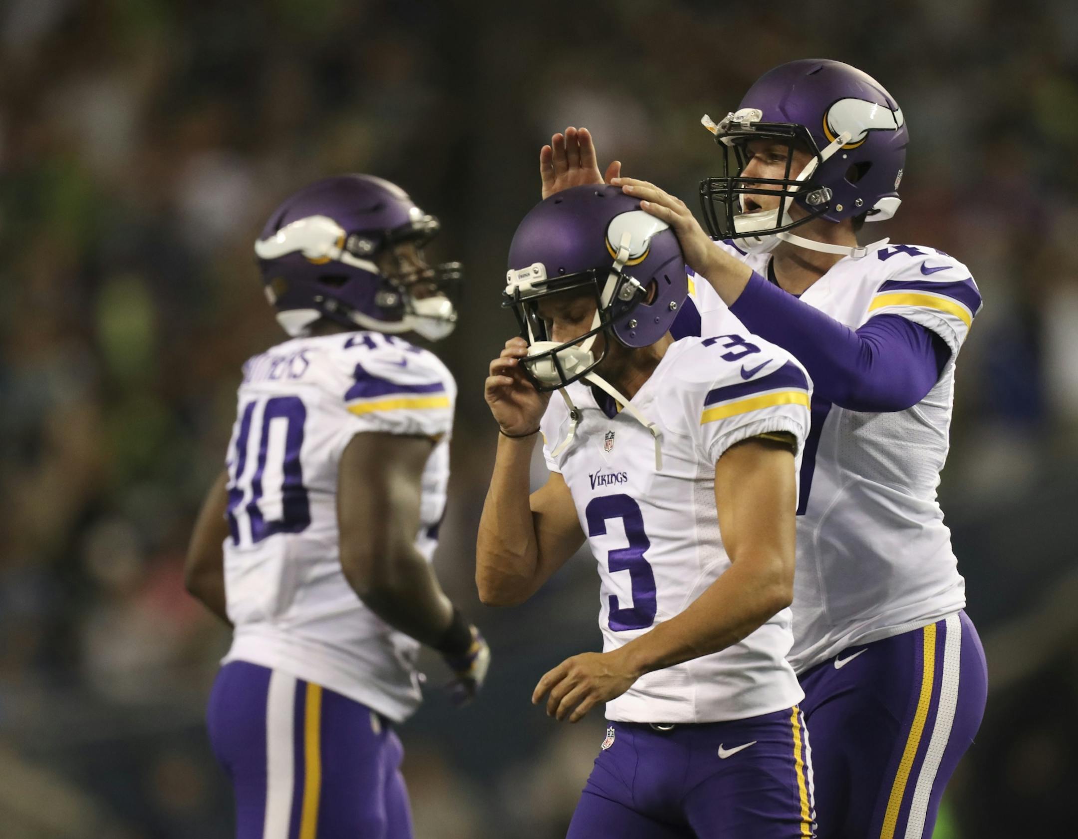 Vikings long snapper Kevin McDermott (47) tapped Vikings kicker Blair Walsh (3) on the helmet after he missed a 47 yard field goal attempt in the fourth quarter Thursday night.