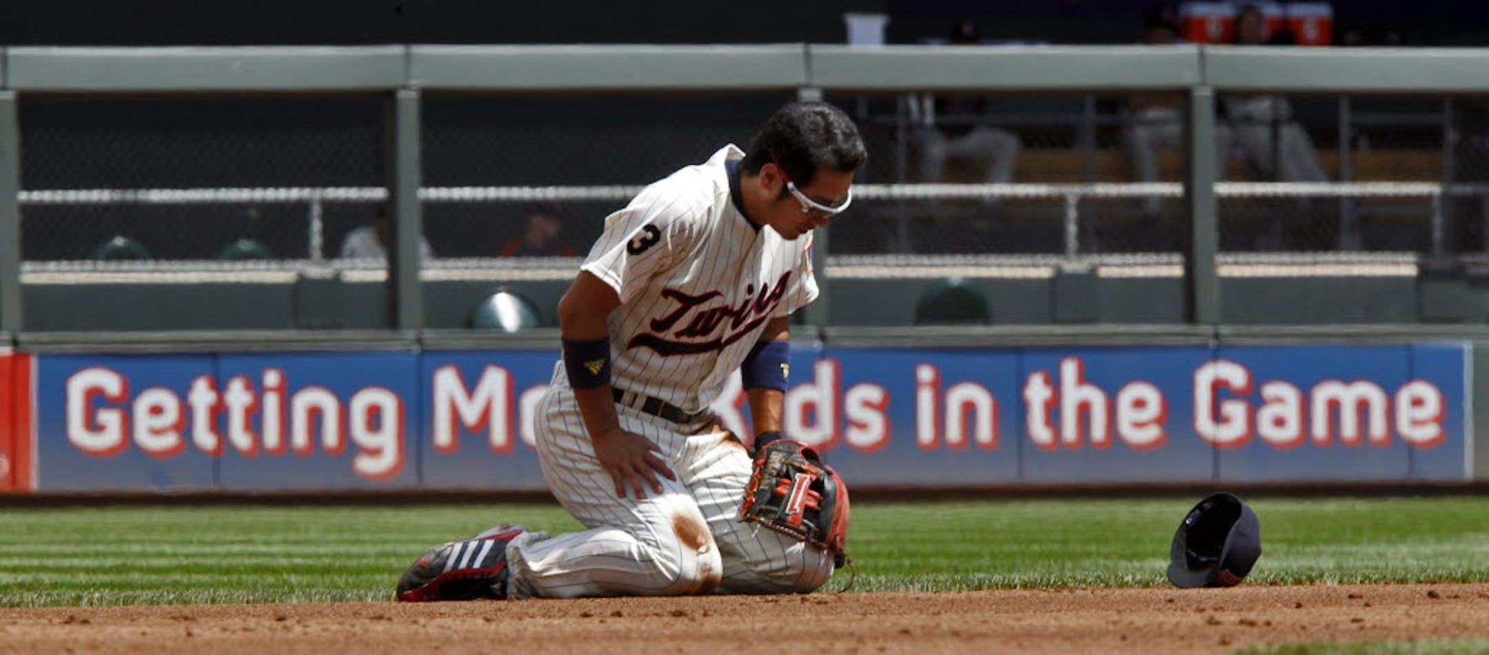 Shortstop Tsuyoshi Nishioka fell to the dirt chasing a ground ball in the hole in the third inning Sunday. But he was able to throw to second base for a force out.