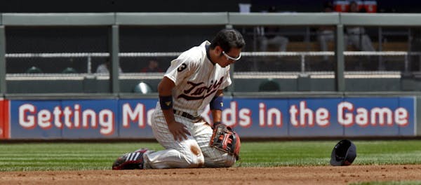 Shortstop Tsuyoshi Nishioka fell to the dirt chasing a ground ball in the hole in the third inning Sunday. But he was able to throw to second base for