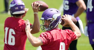 Vikings quarterbacks Kirk Cousins, front, and Jaren Hall (16) throw during the team’s mandatory minicamp in June.