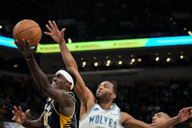 Pacers forward Pascal Siakam, left, shoots in front of Timberwolves forward T. J. Warren on March 7 at Indiana.