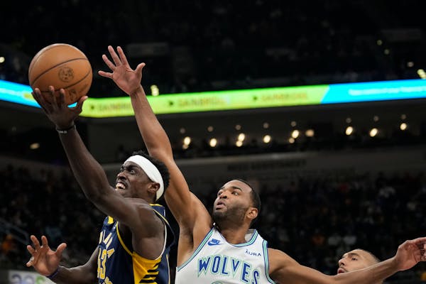 Pacers forward Pascal Siakam, left, shoots in front of Timberwolves forward T. J. Warren on March 7 at Indiana.