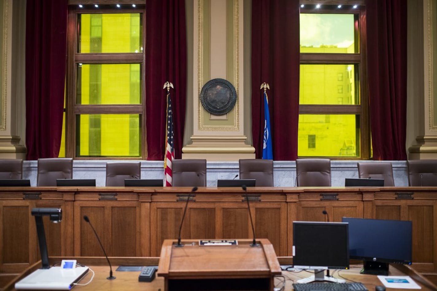 The city council chamber features green-tinted windows. When the windows were clear, the council members appeared greenish on television, and now appear naturally with the green windows behind them.