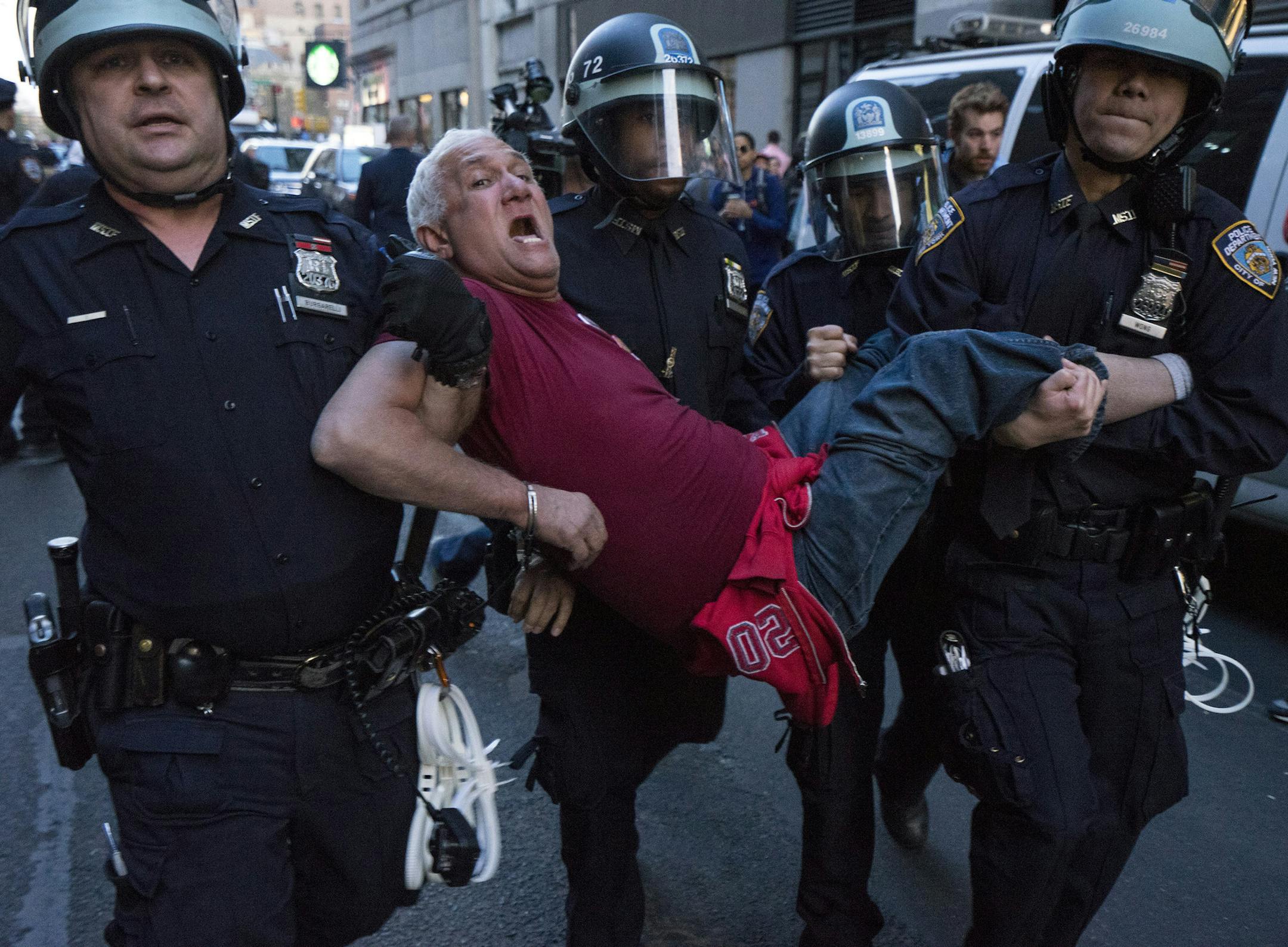 A man is carried by police officers as arrests are made at Union Square, Wednesday, April 29, 2015, in New York. People gathered to protest the death of Freddie Gray, a Baltimore man who was critically injured in police custody. (AP Photo/Craig Ruttle)