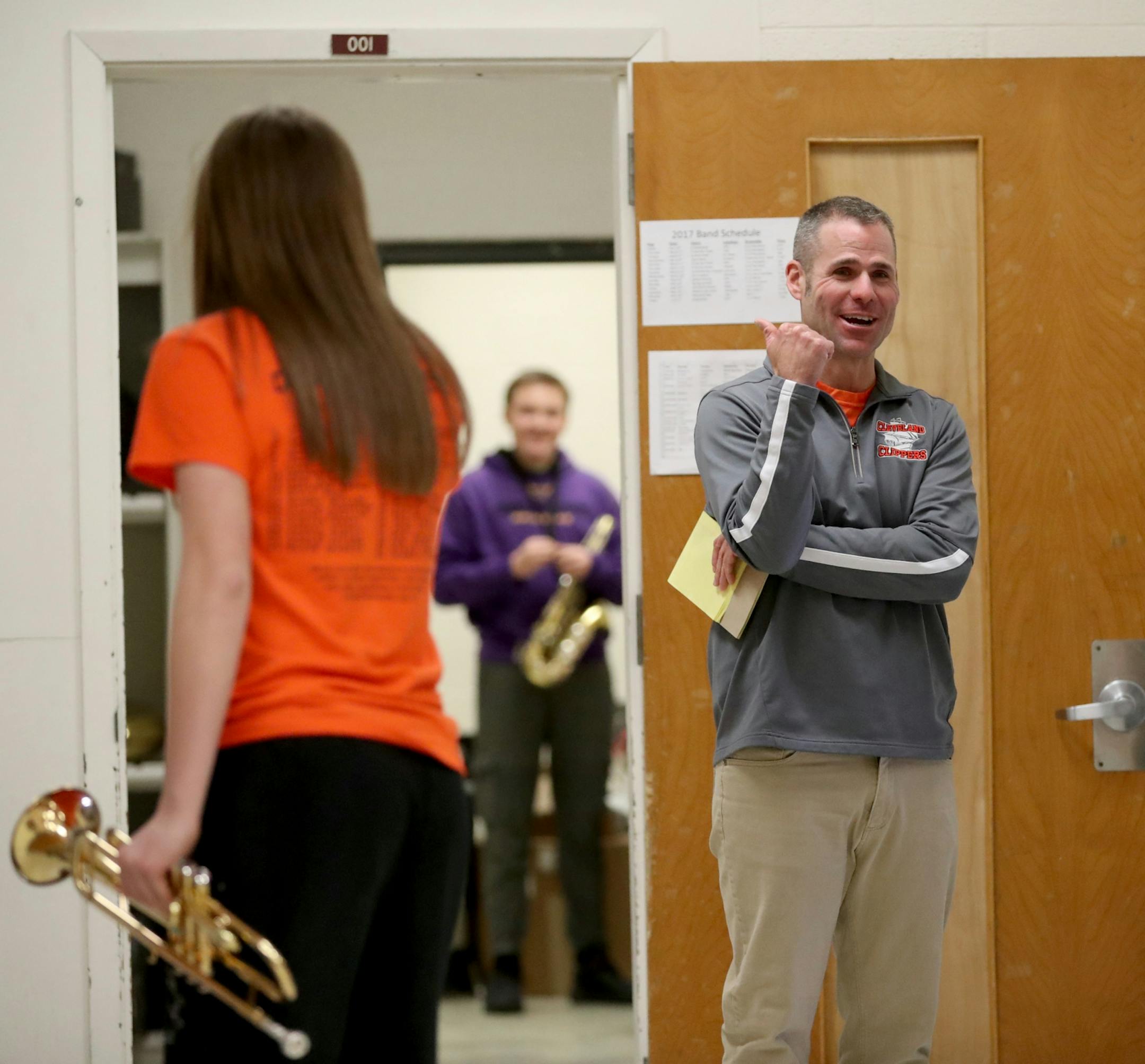 Erik Hermanson, band teacher and football coach at Cleveland Public School, where almost 90 percent of the school's students play in band, chats with students before a lunch hour jazz practice Tuesday, Feb. 21, 20117, in Cleveland, MN.