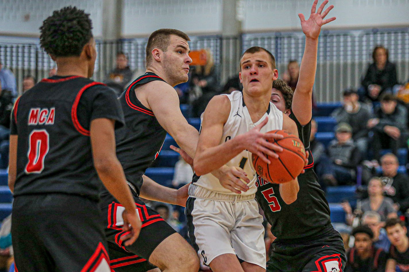 Caledonia's Eli King (with ball) is sought after by college coaches in basketball and football.