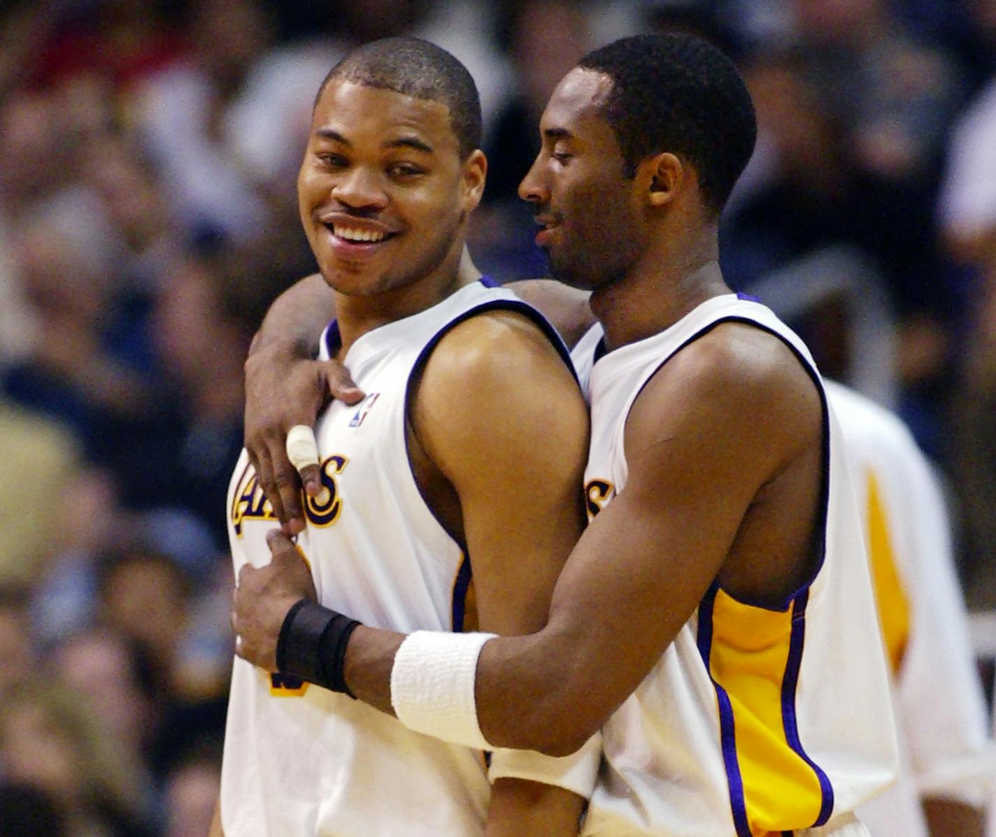 Los Angeles Lakers' Kobe Bryant hugs Devean George during a timeout in the second half agianst the San Antonio Spurs, Sunday, April 4, 2004, in Los Angeles. The Spurs won 95-89. (AP Photo/Mark J. Terrill) ORG XMIT: LAS109