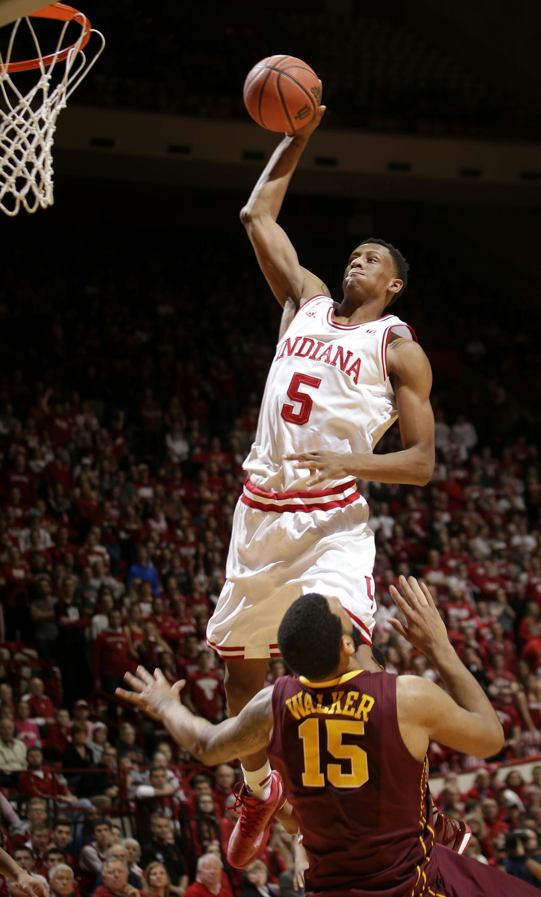 Indiana forward Troy Williams (5) shoots over Minnesota forward Maurice Walker (15) in the second half of an NCAA college basketball game, Sunday, Feb. 15, 2015, in Bloomington, Ind. Williams was called for an offensive foul as Indiana won 90-71. (AP Photo/AJ Mast)