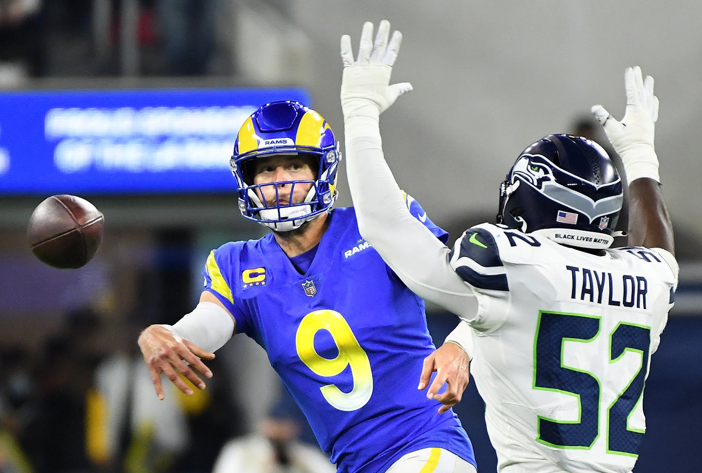 Los Angeles Rams quarterback Matthew Stafford (9) gets a pass off in front of Seattle Seahawks defensive end Darrel Taylor (52) in the second quarter at SoFi Stadium on Tuesday, Dec. 21, 2021, in Inglewood, California. The Rams won, 20-10. (Wally Skalij/Los Angeles Times/TNS) ORG XMIT: 35468302W