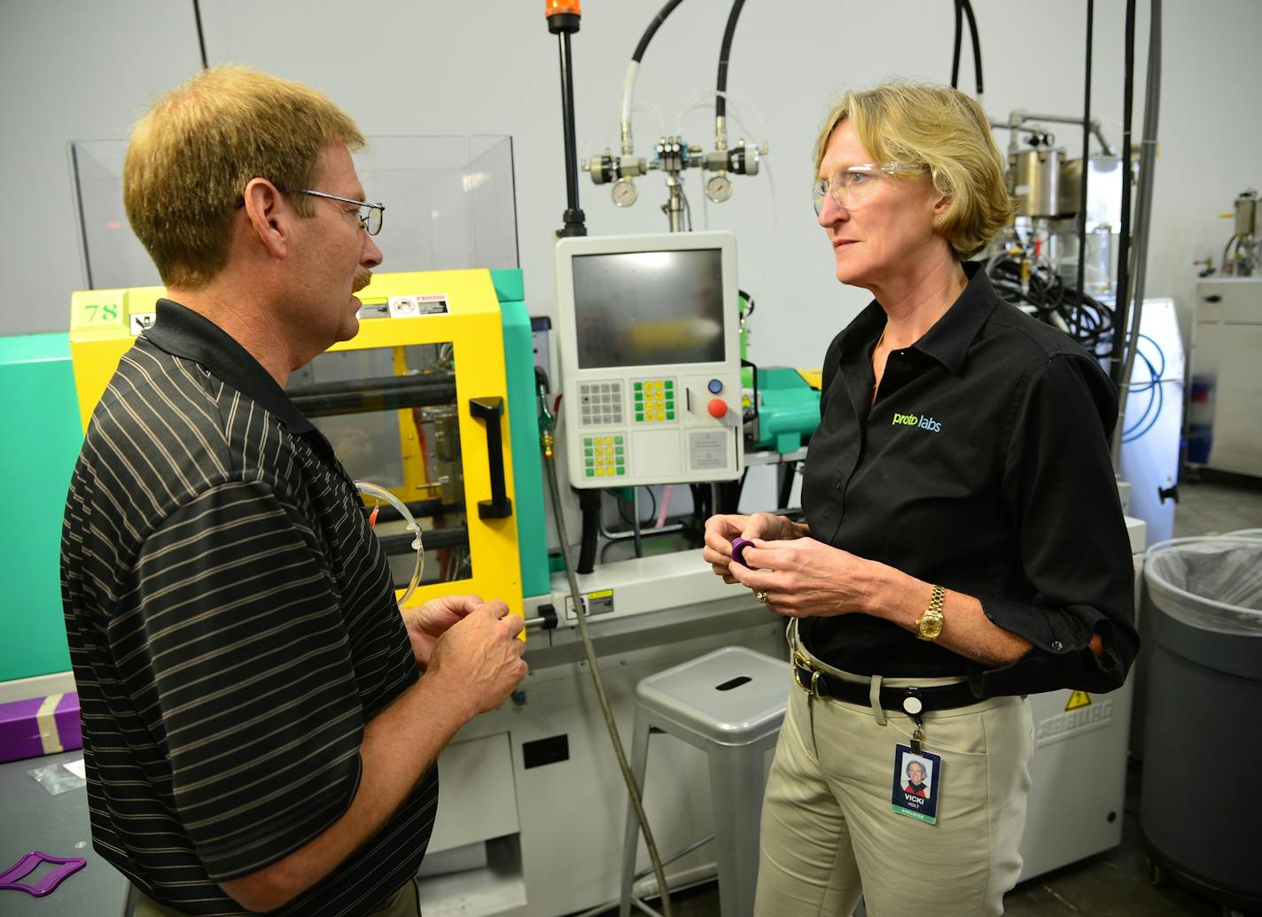 ProtoLabs's new CEO Vicki Holt has been on the job for 16 weeks and in that time negotiated and closed an acquisition, opened up a new $19 million factory and relocated to a new state. She looked over equipment in the injection molding area with Proto Labs silicon rubber injection specialist Rick Bigaouette]Richard.Sennott@startribune.com Richard Sennott/Star Tribune Maple Plain Minn.Thursday 6/26/2014) ** (cq)