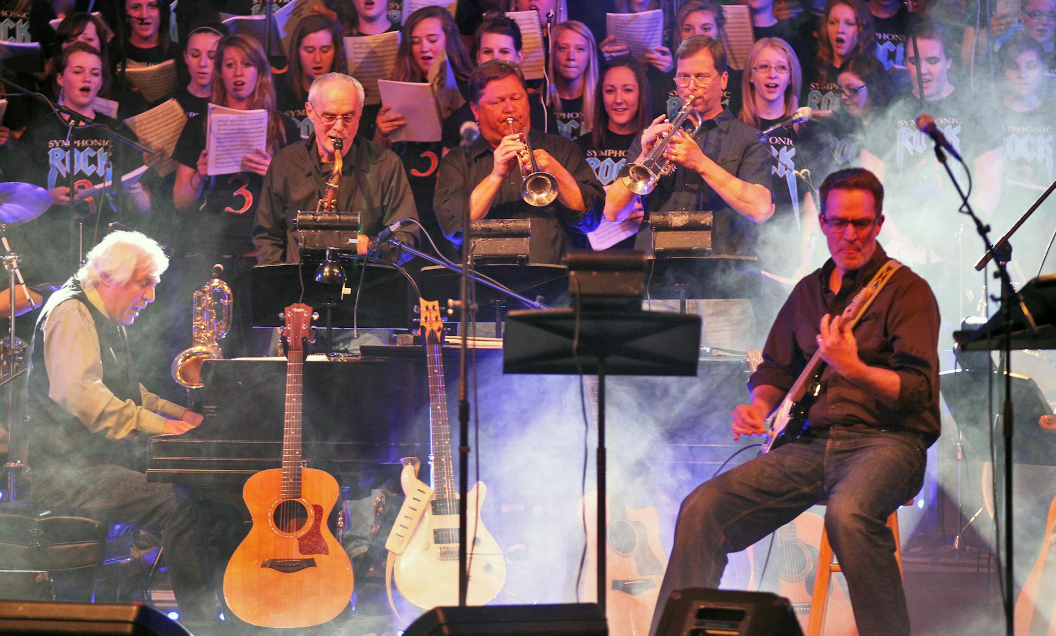 Faculty and staff members of Anoka High have a rock band called Staff Infection that combined with the student symphonic orchestra to perform a recent concert at Anoka high school. Faculty band with student choir behind them. (MARLIN LEVISON/STARTRIBUNE(mlevison@startribune.com (cq all names program)