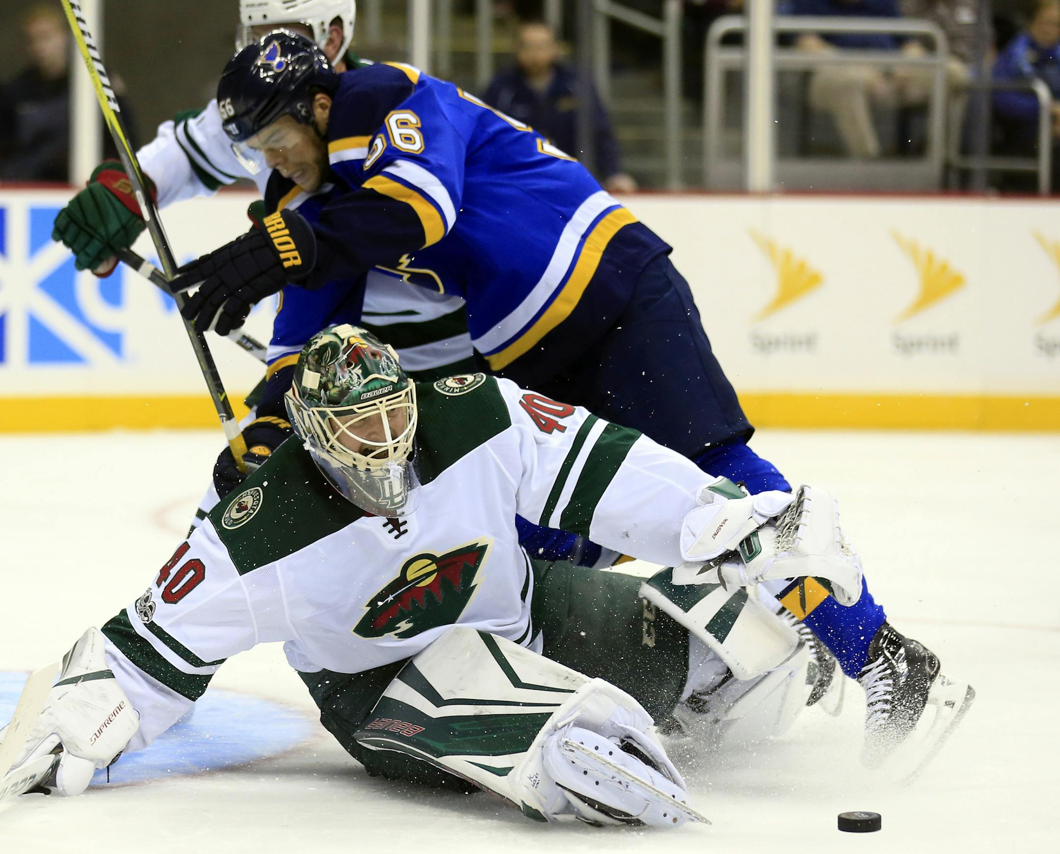 Minnesota Wild goalie Devan Dubnyk (40) makes a save while pressed by St. Louis Blues left wing Magnus Paajarvi (56) during the first period of an NHL preseason hockey game in Kansas City, Mo., Thursday, Sept. 28, 2017. (AP Photo/Orlin Wagner)
