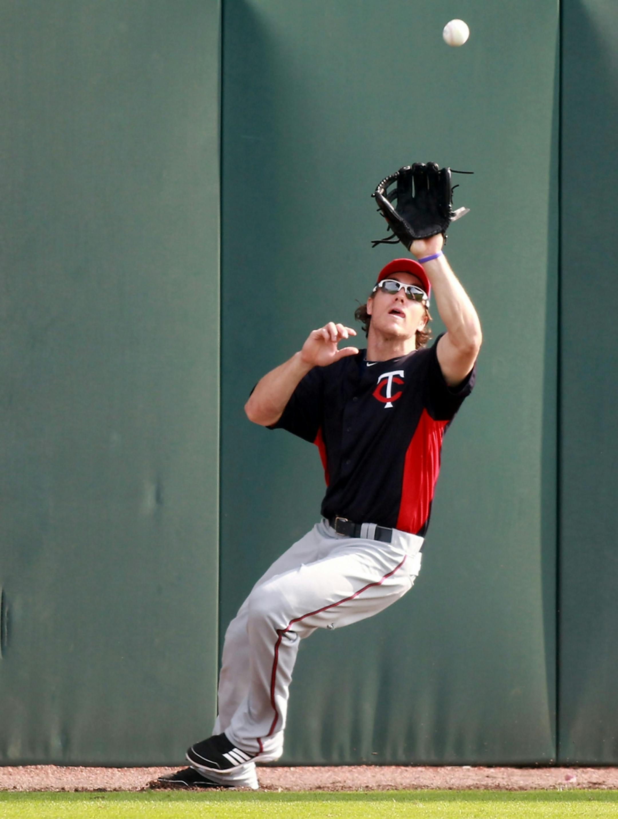 Minnesota Twins Trevor Plouffe made a grab in the outfield Sunday, February 26, 2012 in Ft. Myers, FL. (ELIZABETH FLORES/STAR TRIBUNE) ELIZABETH FLORES � eflores@startribune.com