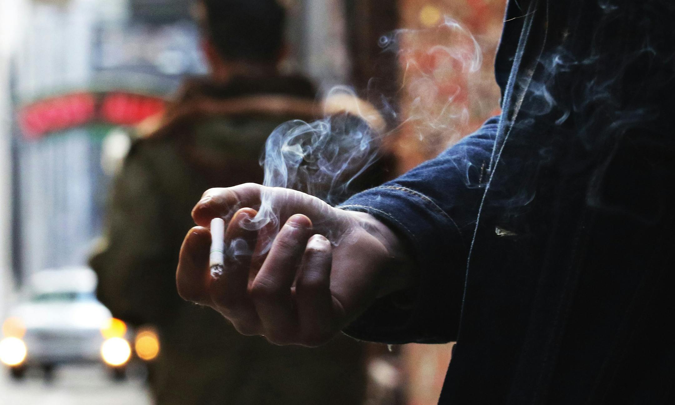 Leyland Foster has a cigarette break in Post Alley, smoking a Camel Crush with a capsule in the filter that, when squeezed, releases menthol flavor. He's been smoking since he was 16, about 14 years. "With coffee, oh yeah." (Alan Berner/Seattle Times/TNS) ORG XMIT: 1219206