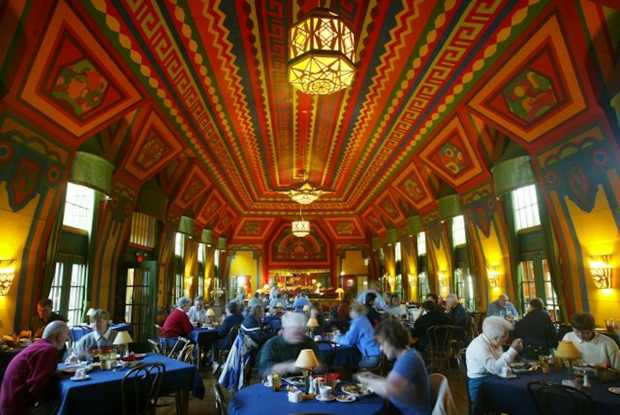 Guests enjoy dinner at the Naniboujou Lodge in the Great Hall. It is decorated with Cree Indian designs and were first painted by designer Antoine Gouffee.