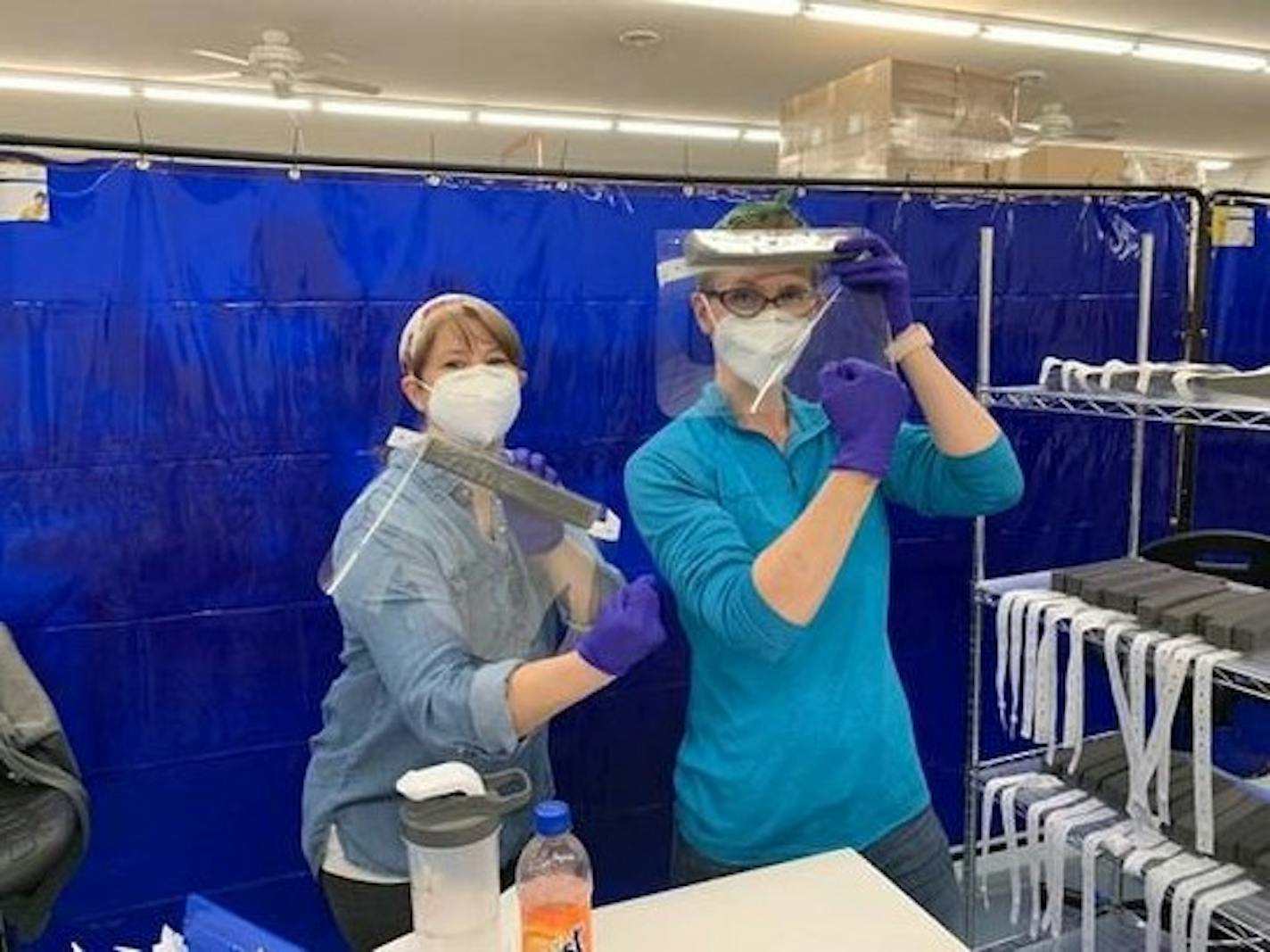 Kathryn Scharnweber and Angela Murphy, both Mayo Clinic medical professionals, have taken temporary assignments making face shields at Pepin Manufacturing in Lake City. (Provided photo)