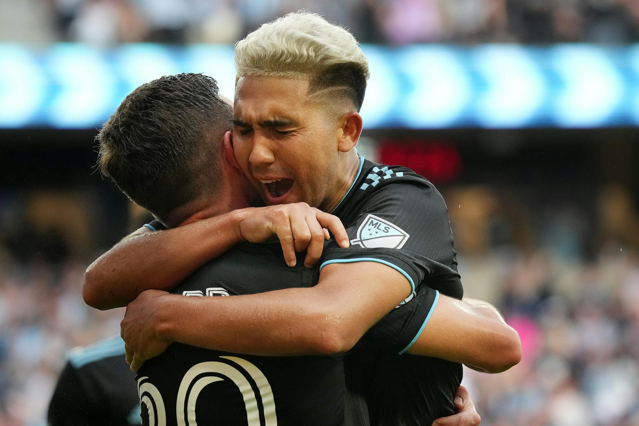 Minnesota United midfielder Emanuel Reynoso (10) celebrates with midfielder Will Trapp (20) after Reynoso's free kick was deflected by a Houston player for a second-half own-goal during an MLS game between Minnesota United and the Houston Dynamo.