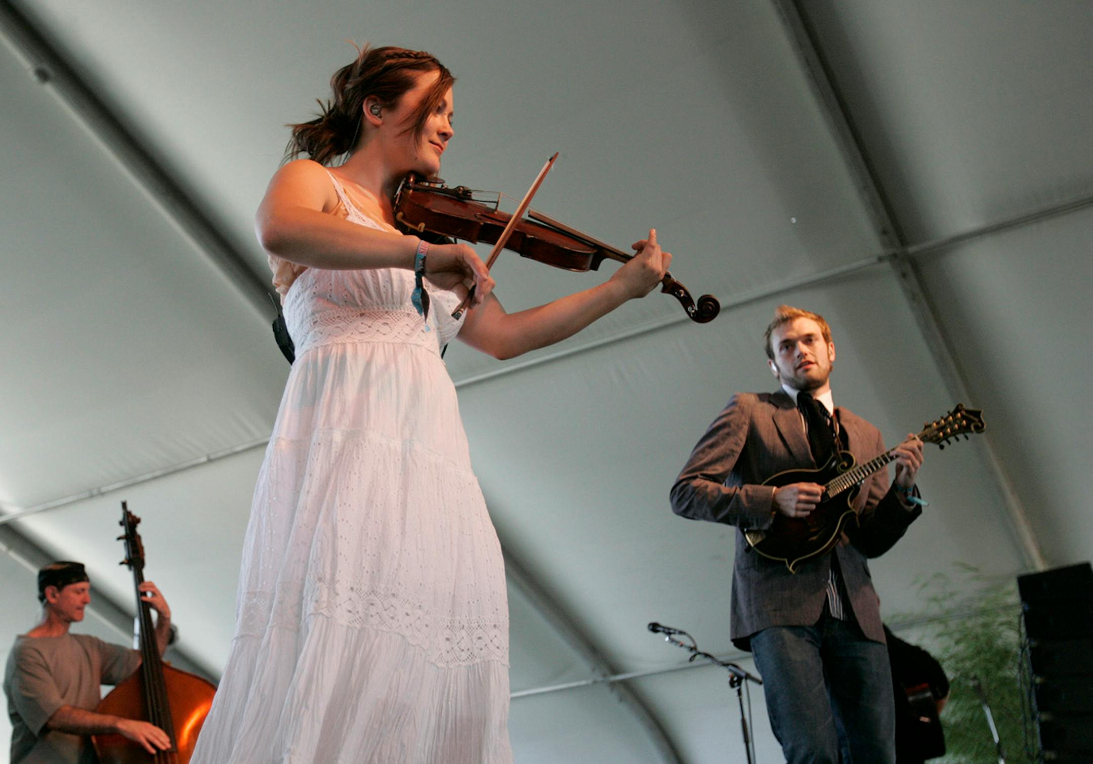 Sara Watkins, center, and Chris Thile, right, of Nickel Creek perform during Stagecoach Country Music Festival at the Empire Polo Fields in Indio, Calif., Saturday May 5, 2007.