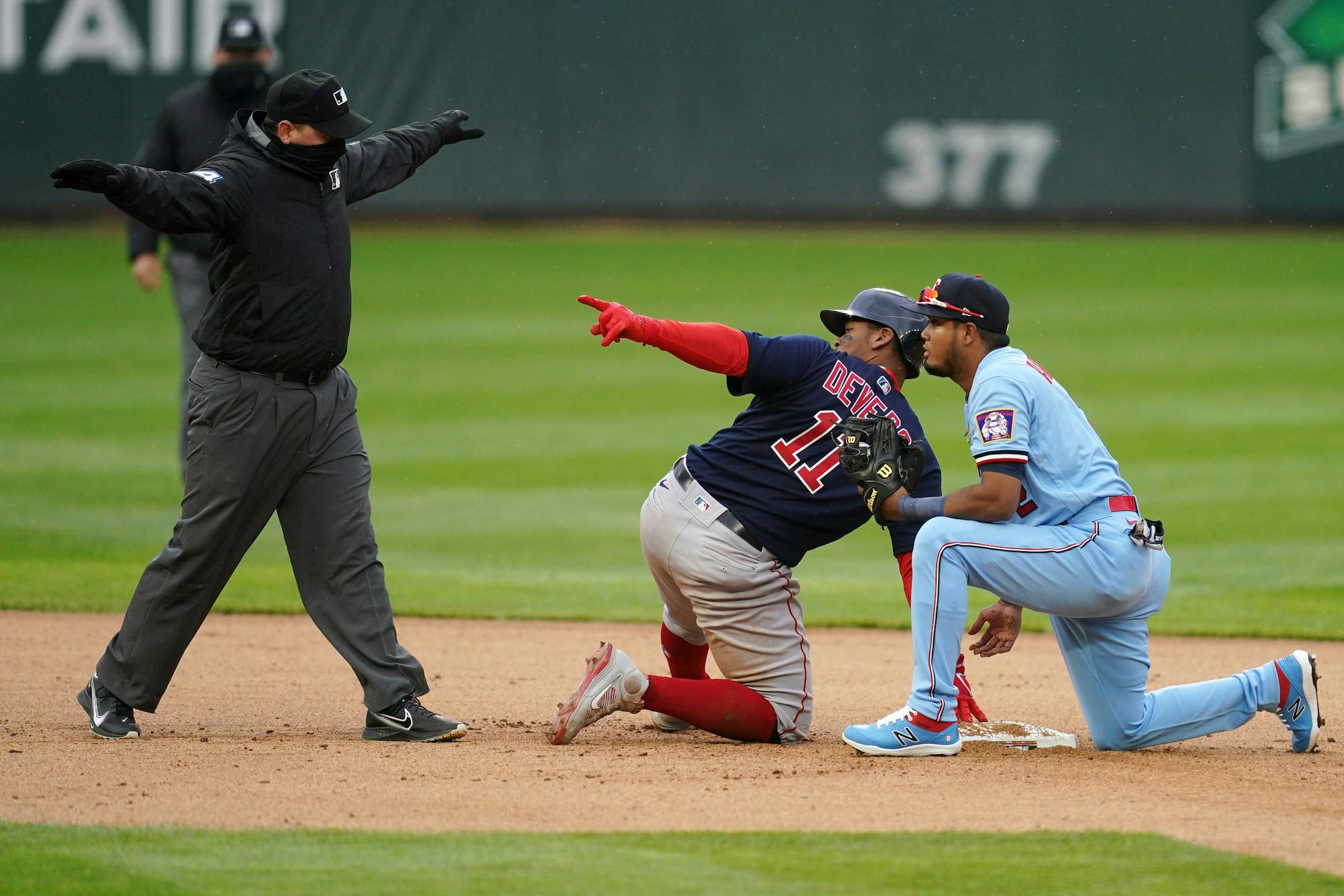 Boston Red Sox third baseman Rafael Devers (11) was called safe at second ahead of the tag by Minnesota Twins second baseman Luis Arraez (2) in the fifth inning of the second game.