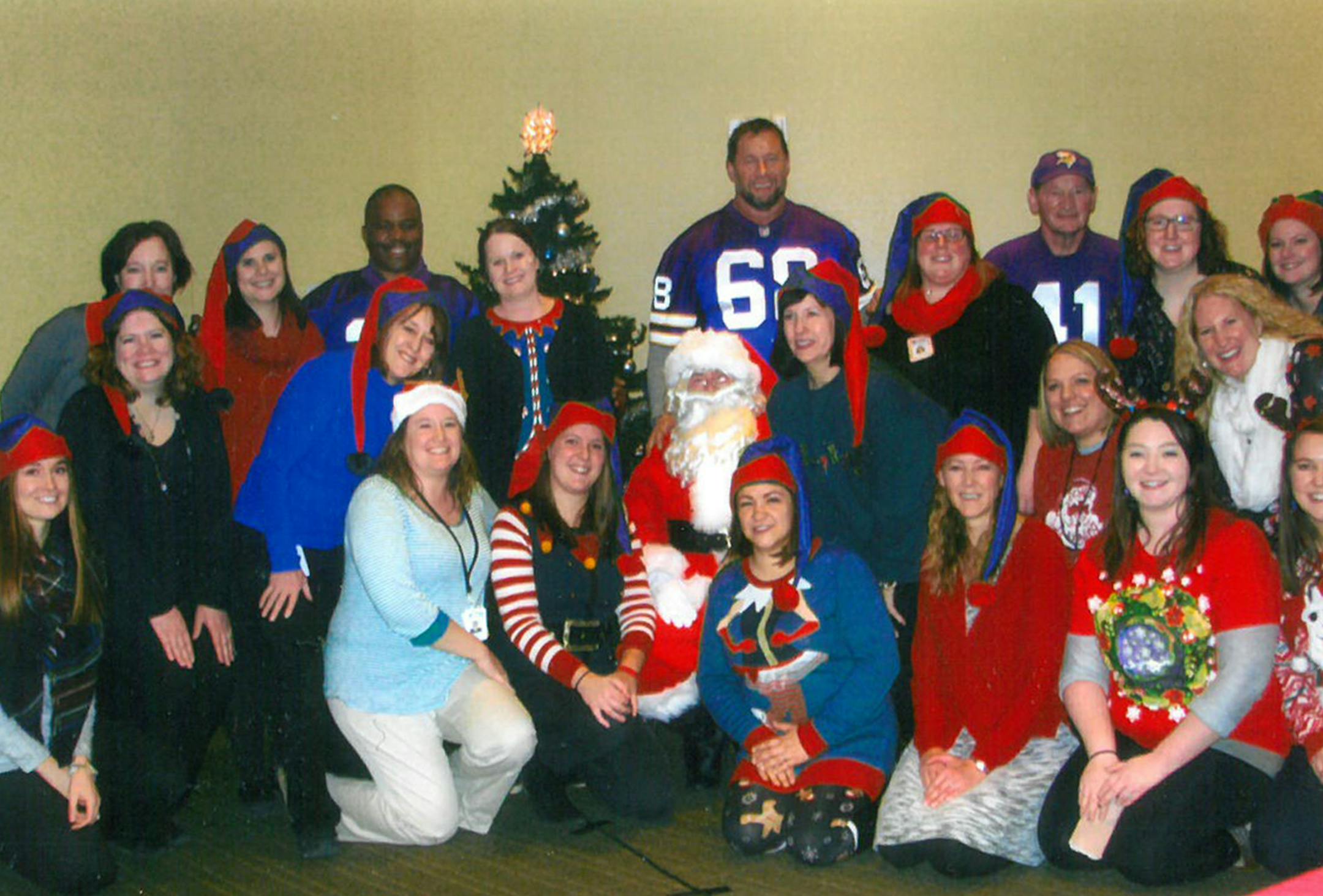 Three former Minnesota Vikings ñ Rufus Bess, Mike Morris and Dave Osborn (all in back row) ñ attended Wright Countyís annual child foster care holiday party in December, where they signed autographs and participated in activities with the kids.