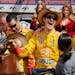 Joey Logano touches the winner trophy in victory lane after winning the NASCAR Sprint Cup Series auto race at Texas Motor Speedway Monday, April 7, 20