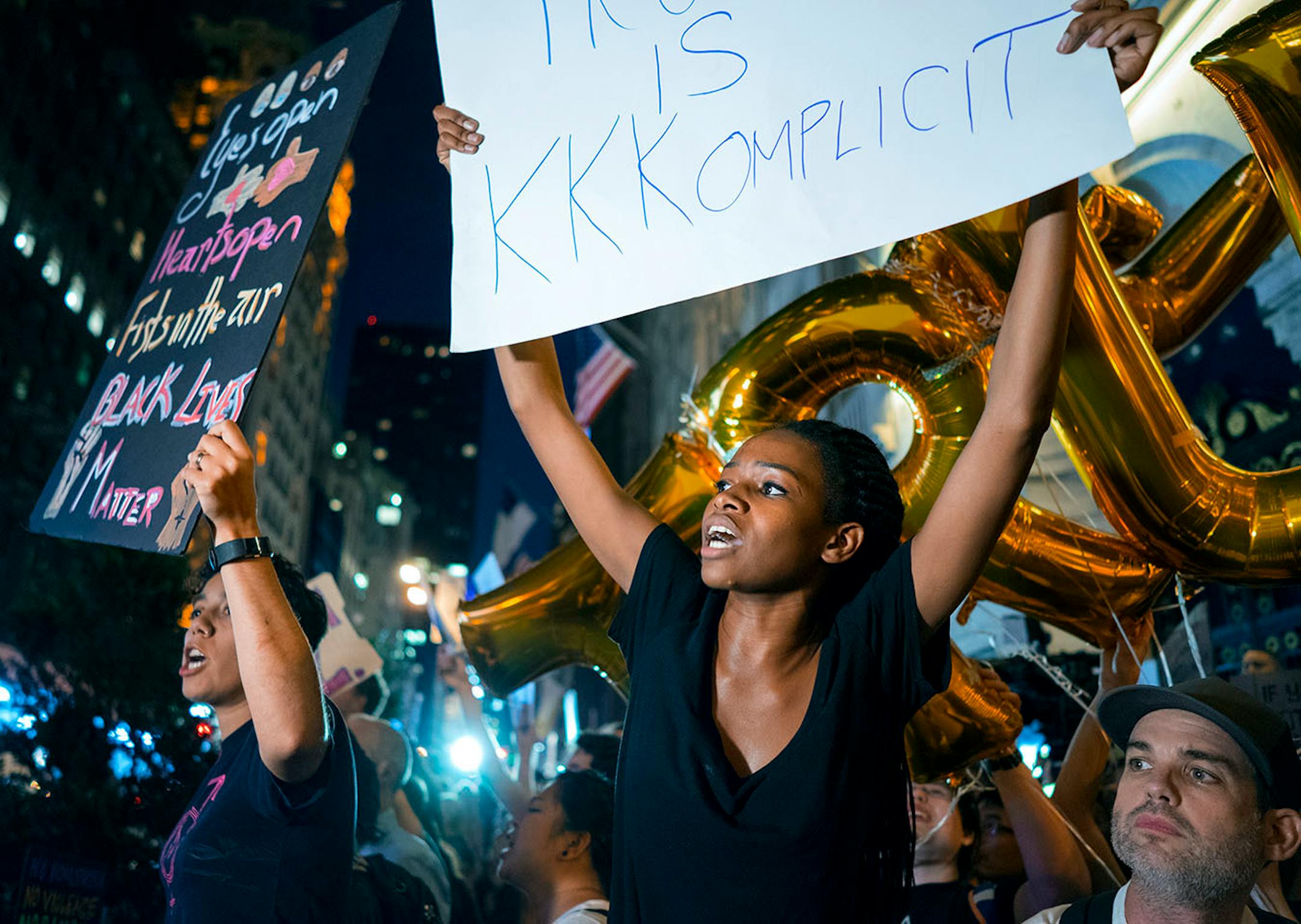 Protestors near Trump Tower react as President Donald Trump arrives Monday, Aug. 14, 2017, in New York. (AP Photo/Craig Ruttle)
