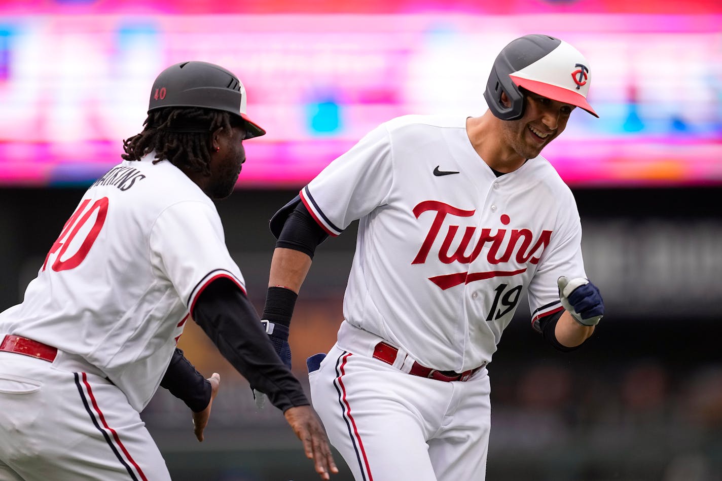 Alex Kirilloff celebrated with third base coach Tommy Watkins after hitting a solo home run during the third inning Saturday