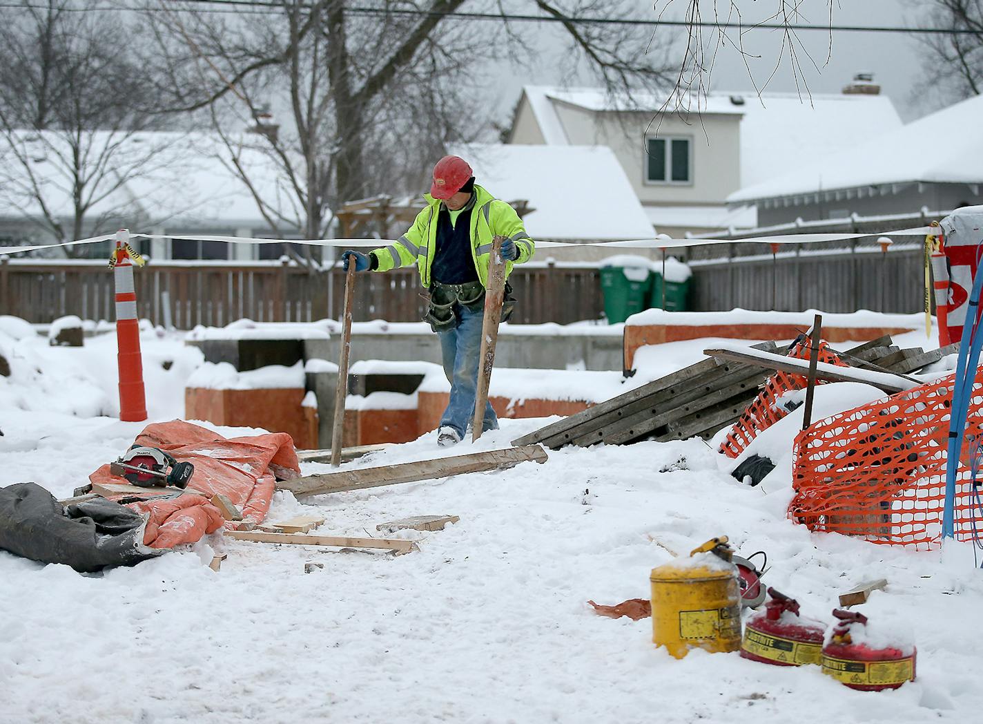 Construction crew worked on a home at 3835 Inglewood Avenue South in St. Louis Park, Wednesday, December 30, 2015. Edina has been in a teardown frenzy, demolishing more than 100 homes a year for the past several years. Yet in St. Louis Park, nearly the same size and sharing a lengthy border, teardowns are running at only about 10 percent of the levels in Edina. ] (ELIZABETH FLORES/STAR TRIBUNE) ELIZABETH FLORES &#x2022; eflores@startribune.com