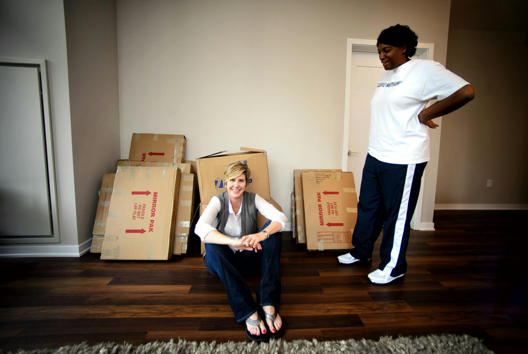 Marlene Stollings, new Gopher's women's basketball coach just moved into her new condo on Nicollet Mall in Minneapolis. She just hired new assistant coach Niki Dawkins, right. The two were on their way to a team photo shoot at the University of Minnesota. ] September 19, 2014 GLEN STUBBE * gstubbe@startribune.com