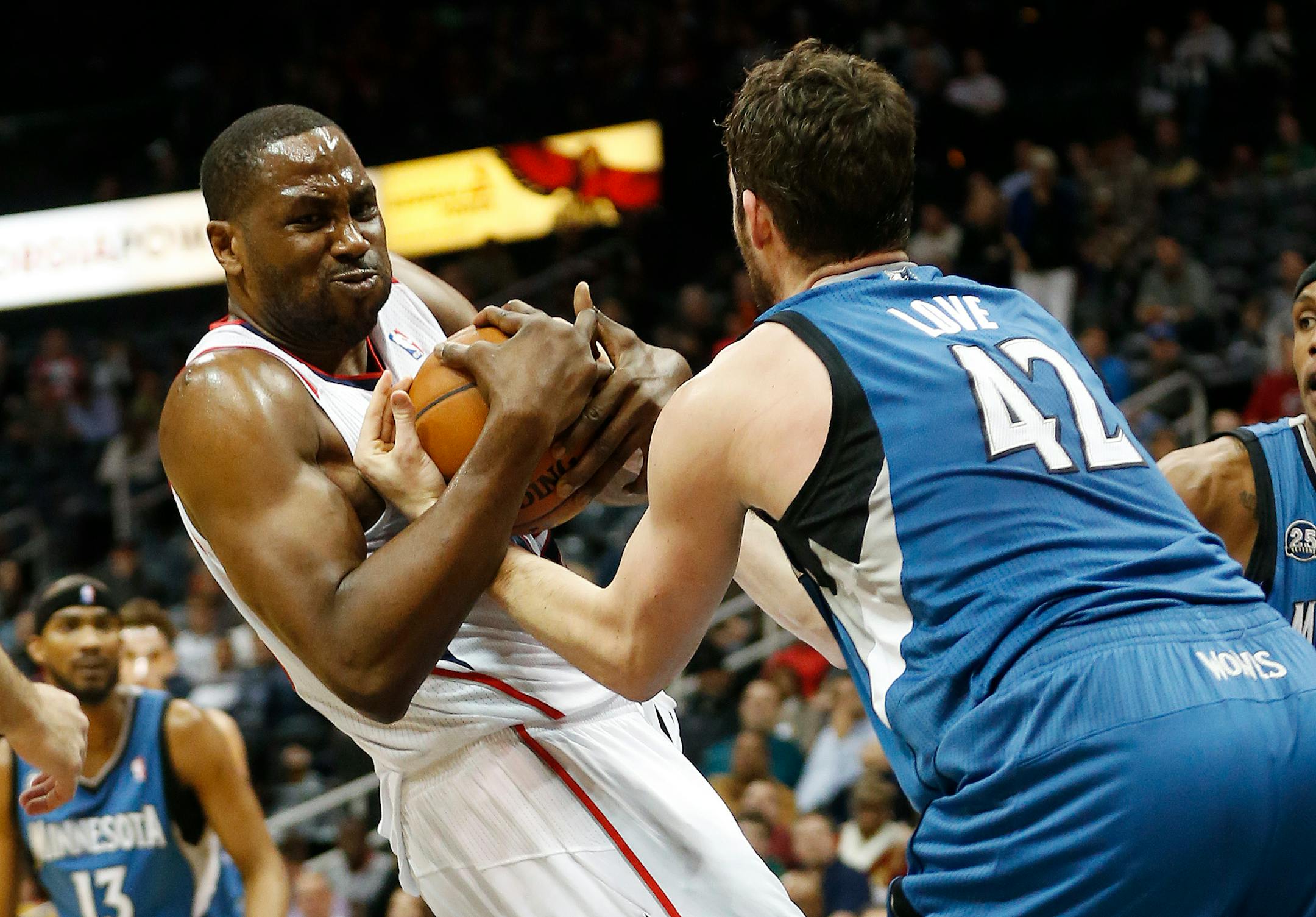 Atlanta Hawks forward Elton Brand and Minnesota Timberwolves Kevin Love, right, struggle for a rebound in the first half of an NBA basketball game, Saturday, Feb. 1, 2014, in Atlanta. (AP Photo/John Bazemore)