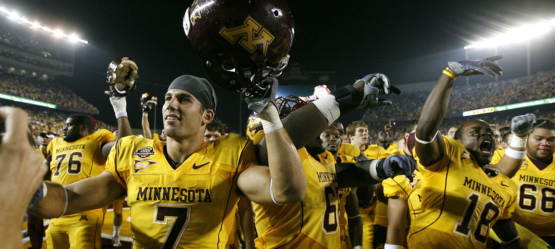 Gophers players, including Eric Decker (7) celebrate their 20-13 win over Air Force in the first game at TCF Bank Stadium.