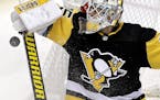 Pittsburgh Penguins goaltender Tristan Jarry stops a shot during the first period of an NHL hockey game against the Montreal Canadiens in Pittsburgh, 