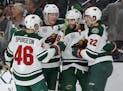 Minnesota Wild players celebrate after Jason Zucker, second from right, scored against the Vegas Golden Knights during the first period of an NHL hock