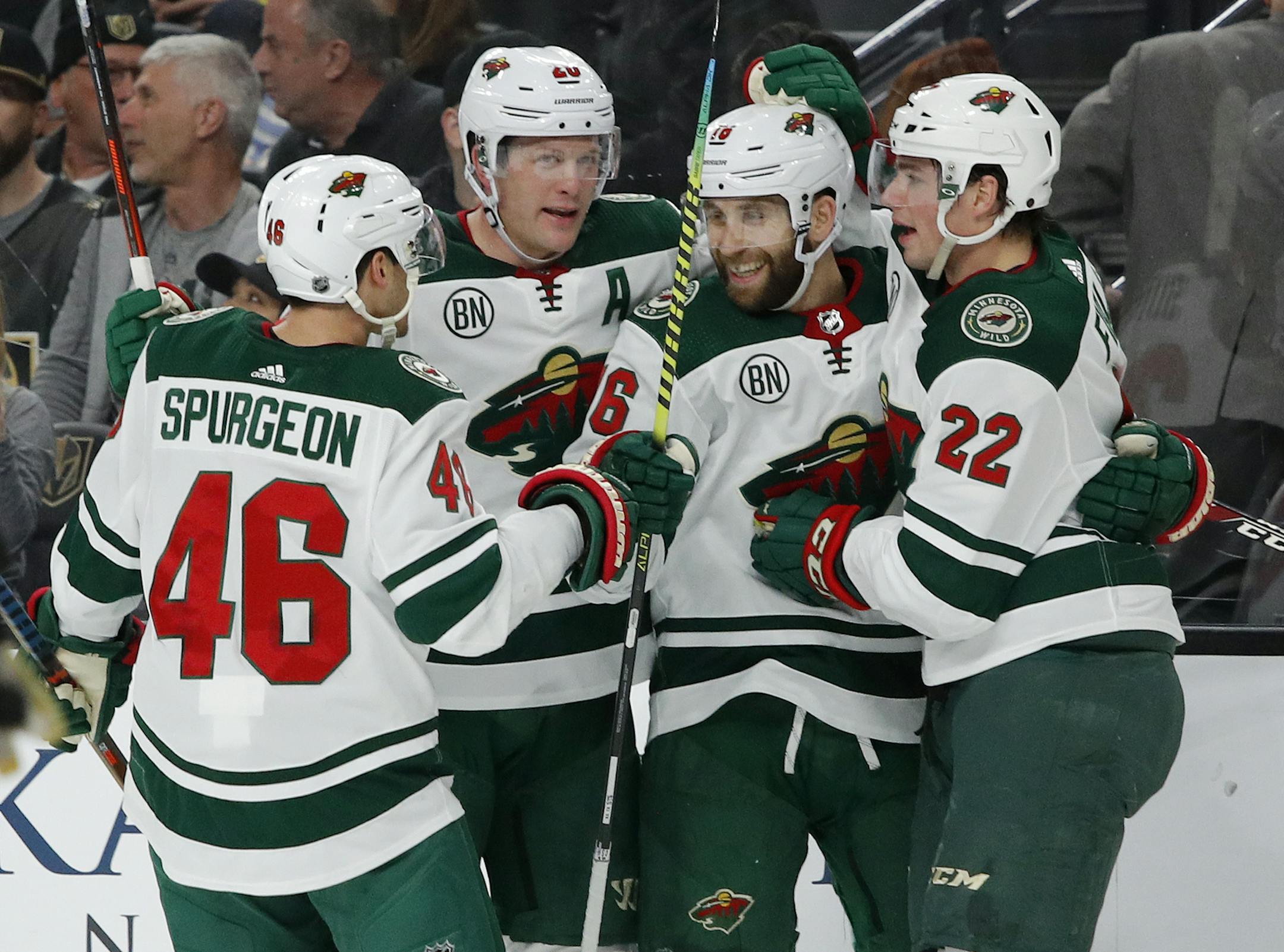 Minnesota Wild players celebrate after Jason Zucker, second from right, scored against the Vegas Golden Knights during the first period of an NHL hockey game Friday, March 29, 2019, in Las Vegas. (AP Photo/John Locher)