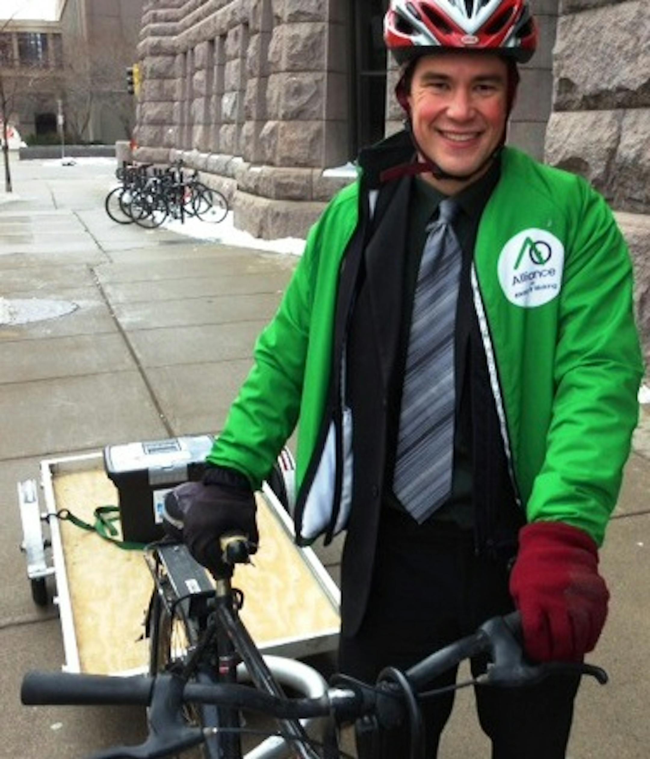 Ethan Fawley arrived Tuesday at Minneapolis City Hall hauling a bike trailer with a box containing about 3,400 postcards collected in support of protected bike lanes. Fawley is executive director of the Minneapolis Bicycle Coalition.