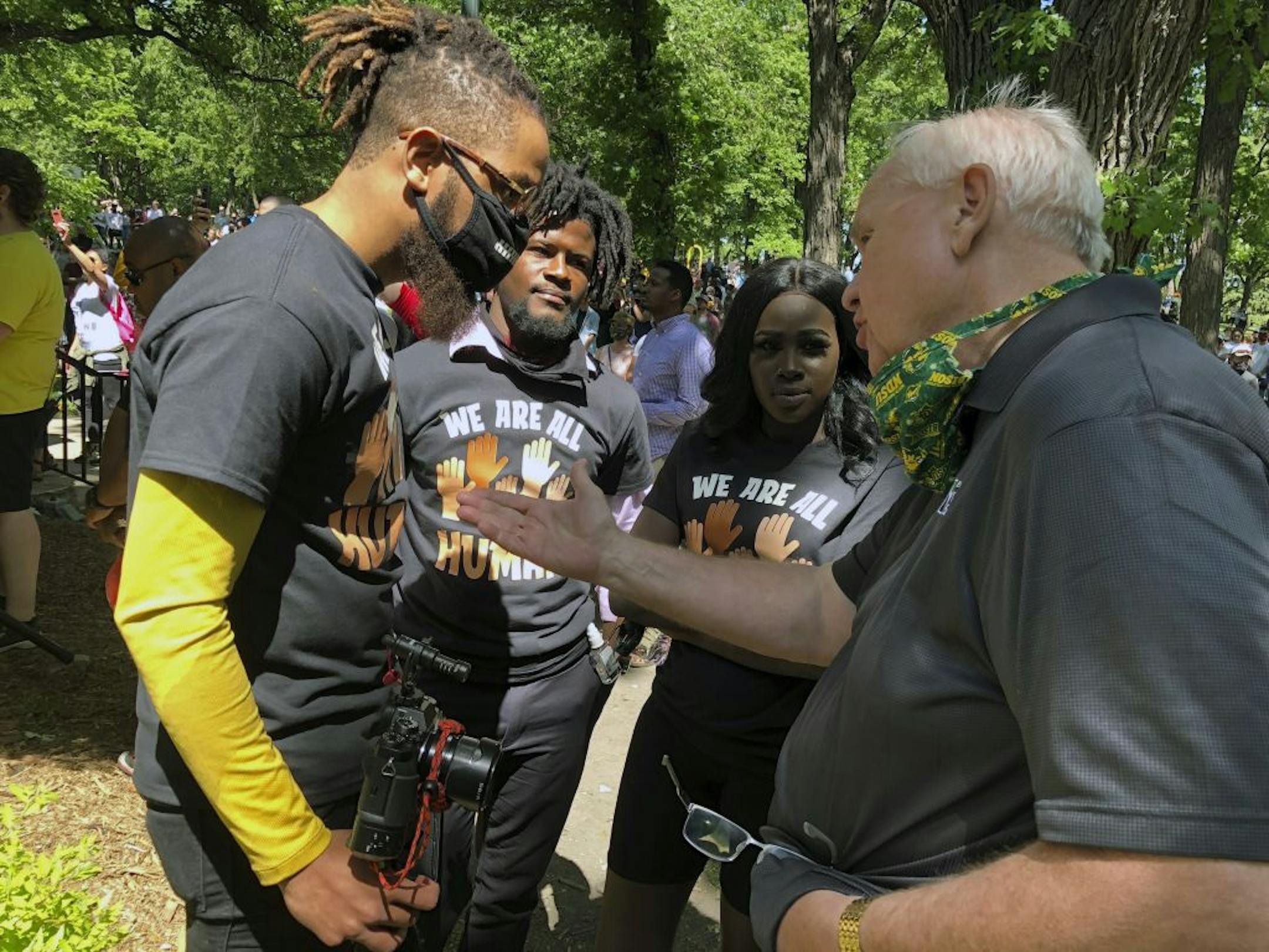 Wess Philome, left, the lead organizer of a George Floyd memorial in Fargo, N.D., talks with West Fargo City Commission Chairman Bernie Dardis, right, Friday, June 5, 2020, The OneFargo event was billed as a celebration and Philome said afterward that "something beautiful happened here today." It drew hundreds of people to a downtown park.
