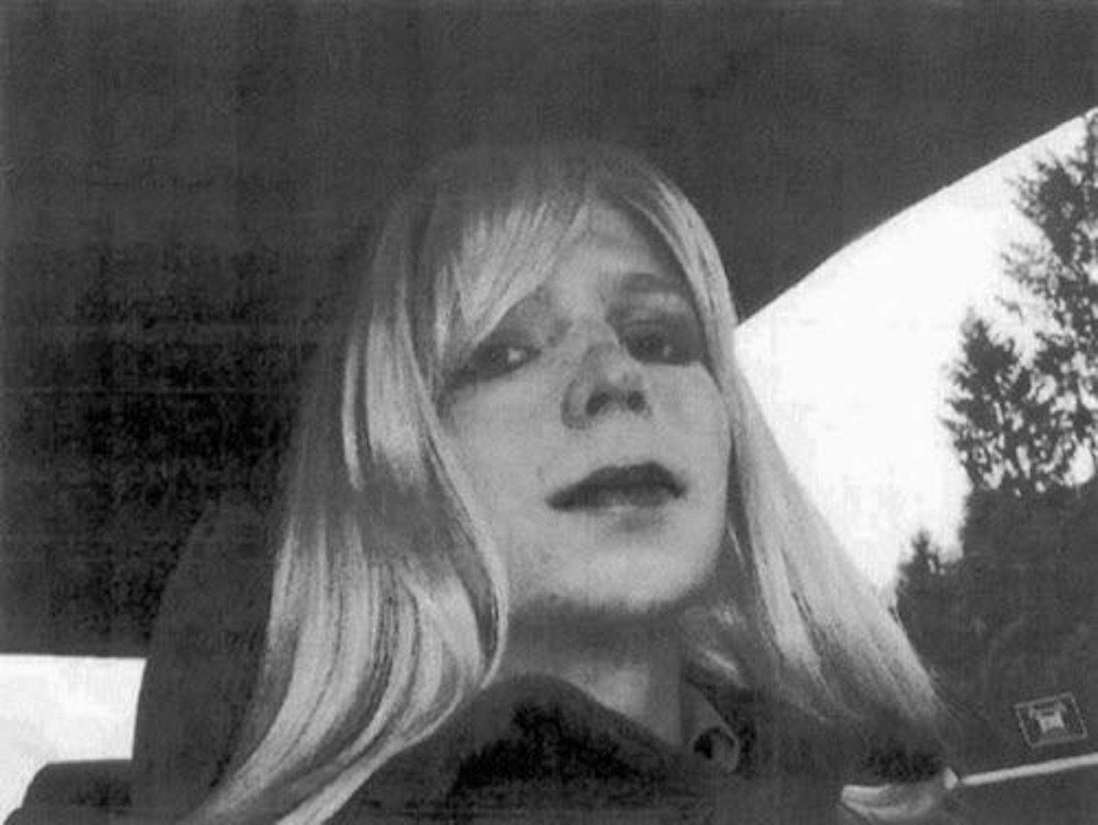 FILE - This undated file photo provided by the U.S. Army shows Pfc. Chelsea Manning wearing a wig and lipstick. Harvard University reversed its decision to name Chelsea Manning a visiting fellow early Friday, Sept. 15, 2017, a day after CIA Director Mike Pompeo scrapped a planned appearance over the title for the soldier who was convicted of leaking classified information.