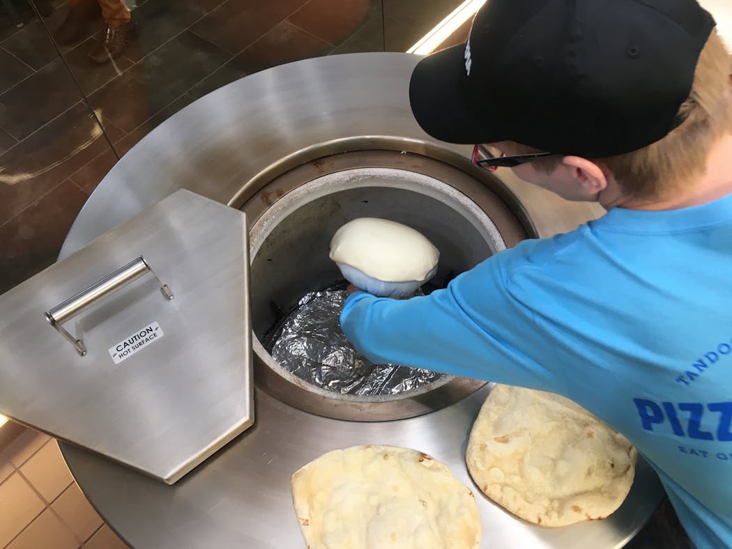 The pizza crust is made naan-style in tandoor ovens at Pizza Karma.