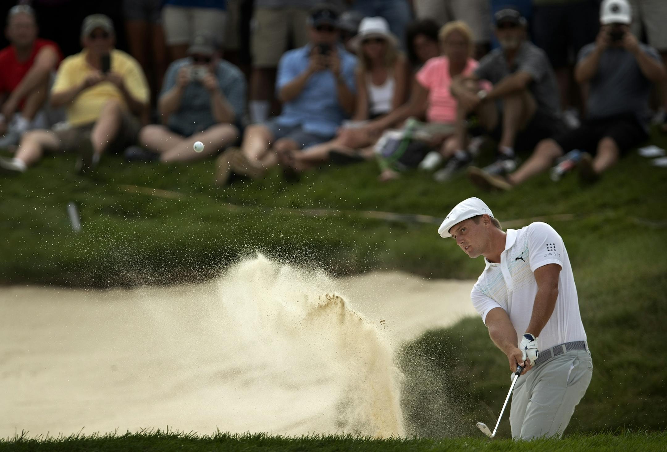 Bryson Dechambeau hits out of the sand at 18 during third round action at TPC Twin Cities Saturday July,6 2019 in Blaine, MN.