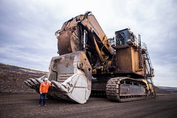 Mike Bakk, U.S. Steel’s Minnesota-based director of operational readiness, posed by a hydraulic shovel in Keewatin, Minn., in 2022. These machines a