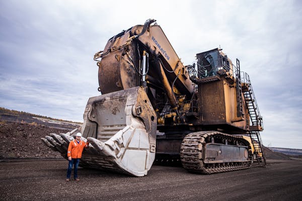 Mike Bakk, U.S. Steel’s Minnesota-based director of operational readiness, posed by a hydraulic shovel in Keewatin, Minn., in 2022. These machines a