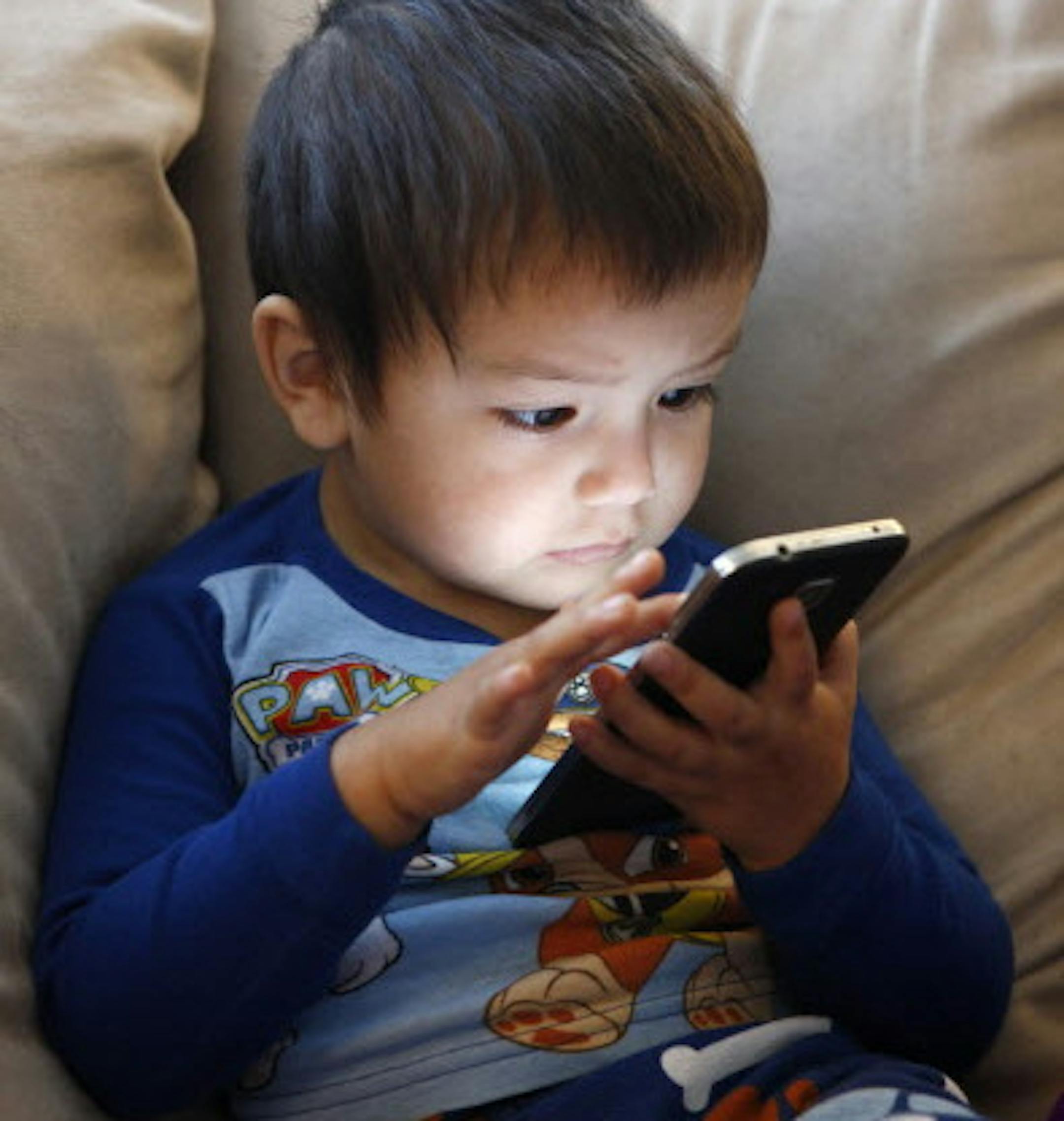 Francisco Sanchez Jr., 2, is engrossed in a Ninja Turtle program on YouTube on his parent's cell phone at their home on Monday, March 9, 2015 in Mountain House, Calif. When Google launched its YouTube Kids service, allowing parents to control what their children watch, it marked Silicon Valley's biggest step in gaining a lucrative and an untapped children's market. (Gary Reyes/Bay Area News Group/TNS) ORG XMIT: 1165164