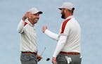Team Europe's Sergio Garcia and Jon Rahm celebrate on the 16th hole during a four-ball match the Ryder Cup