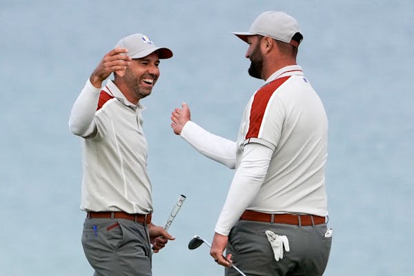 Team Europe's Sergio Garcia and Jon Rahm celebrate on the 16th hole during a four-ball match the Ryder Cup