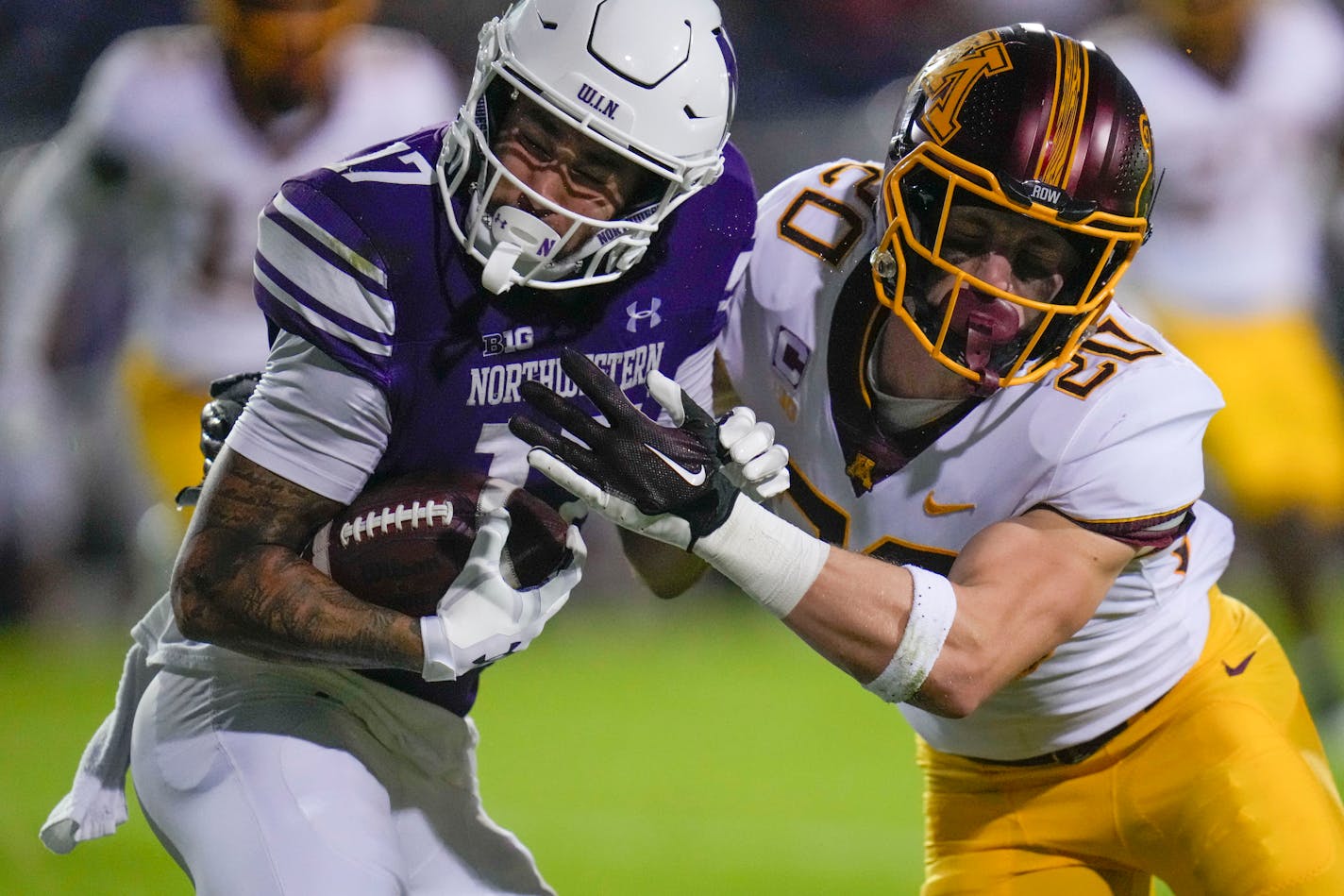 Gophers defensive back Jack Henderson puts a hit on Northwestern wide receiver Bryce Kirtz during the first half