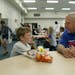 Joey Bergdahl of Blaine sat with his son Dewey, 8, for lunch at Woodcrest Ele­mentary Thursday. Bergdahl said the lunch program is superior to fast f