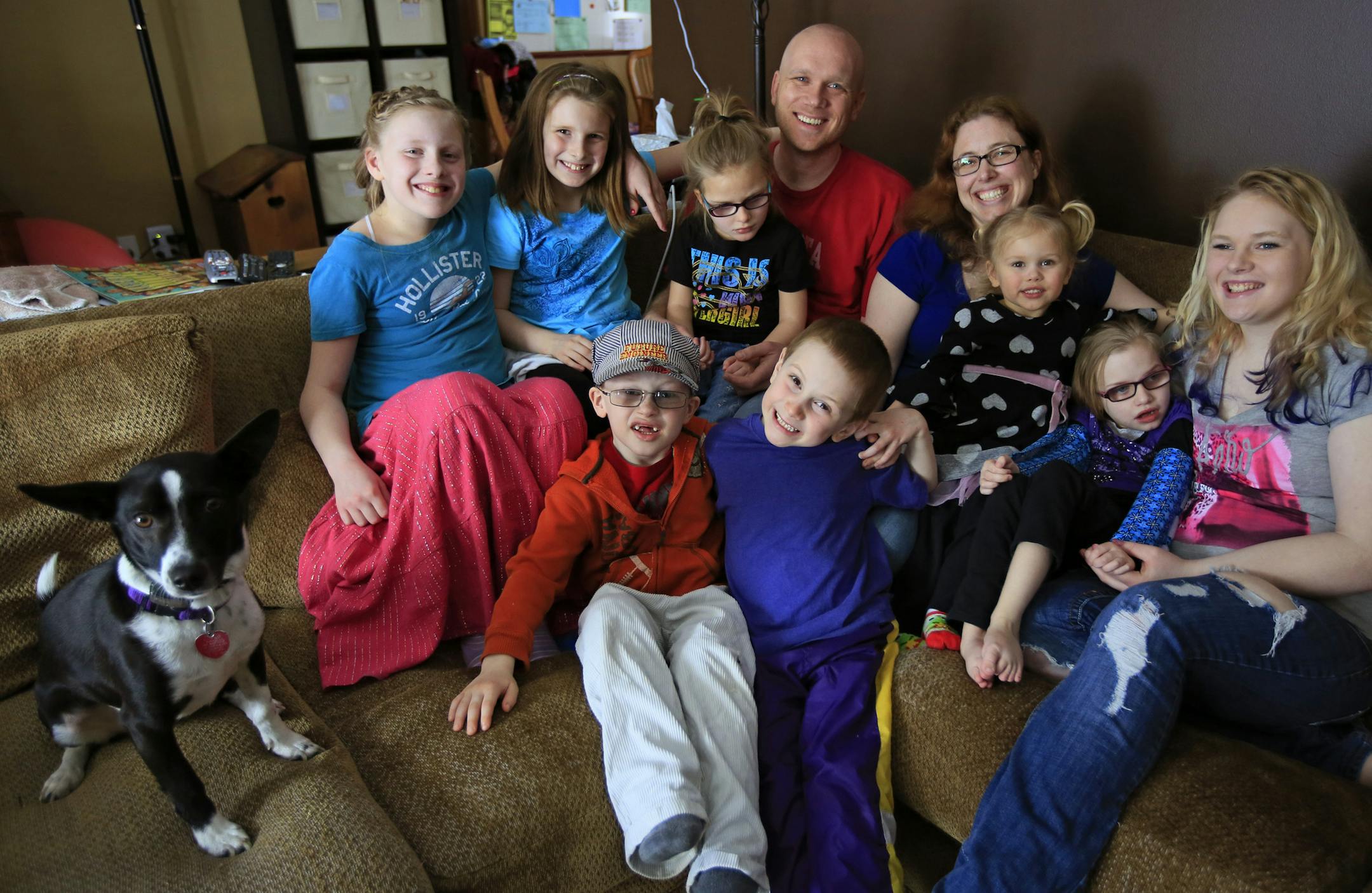 Jennifer and Nathan Johnson both grew up only children. It looked like their child would grow up an only too until the Coon Rapids couple adopted six foster children last fall. The children are all from the same birth family. (L to R Back row) Josephine, 12, Hannah, 11, Emma, 5, Nathan, Jennifer, Gabby, 3, Katrina, 9 and Danielle, 16. (Front Row) Nathan, 5 and Sam, 7. ] Coon Rapids, MN - 03/12/2012