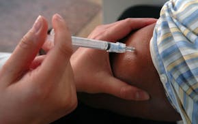The University of Minnesota's Boynton Health Service tries to set a Guinness World Redord for the most flu shots given in a single day. In this pictur
